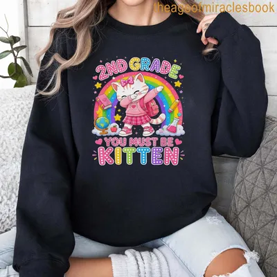 Kawaii-style T-shirt featuring a cute cat with a backpack and colorful text. — printed on a sweatshirt