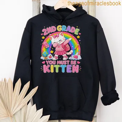 Kawaii-style T-shirt featuring a cute cat with a backpack and colorful text. — printed on a unisex hoodie