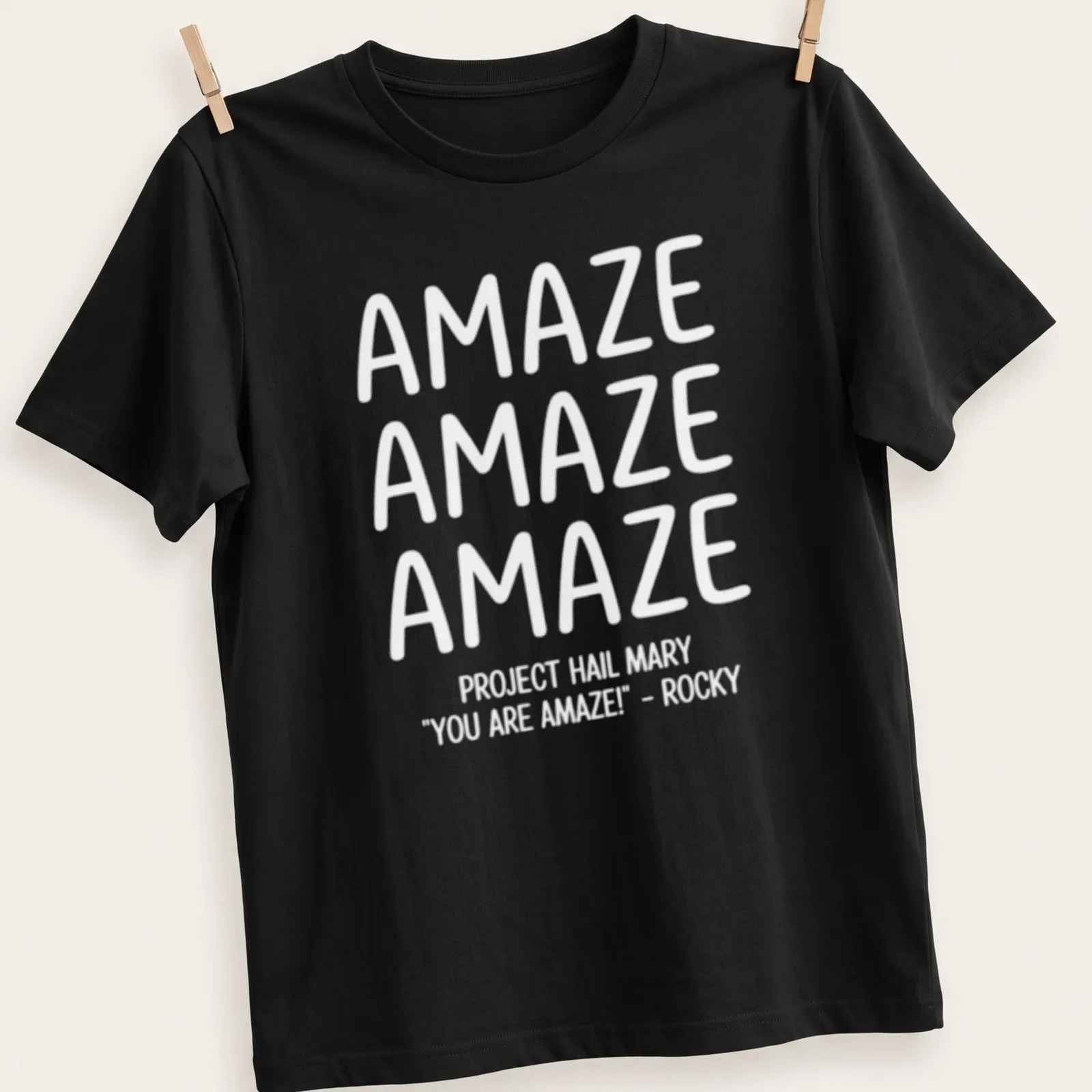 Bold typography t-shirt featuring repeated text 'AMAZE' in white — printed on a unisex t-shirt