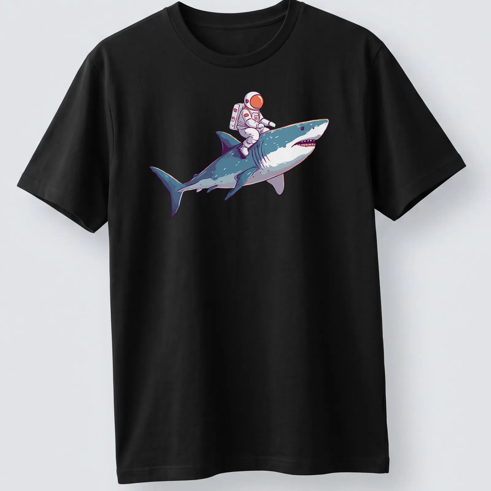 Playful cartoon of an astronaut riding a shark in vibrant colors — printed on a unisex t-shirt