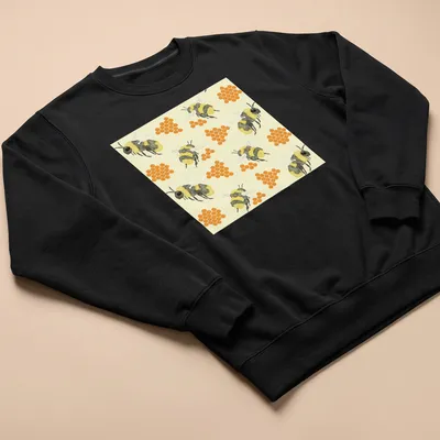 Watercolor print featuring bees and honeycombs in vibrant colors. — printed on a unisex sweatshirt