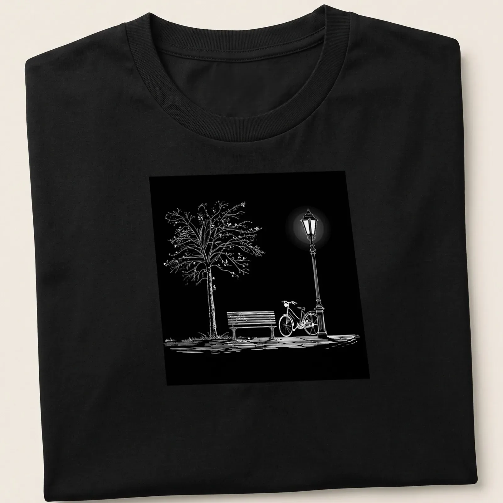 Minimalist black and white design featuring a bicycle, park bench, lamppost, and tree — printed on a unisex t-shirt
