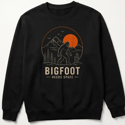 Line art design of Bigfoot with the text Bigfoot Needs Space in orange and beige — printed on a unisex sweatshirt