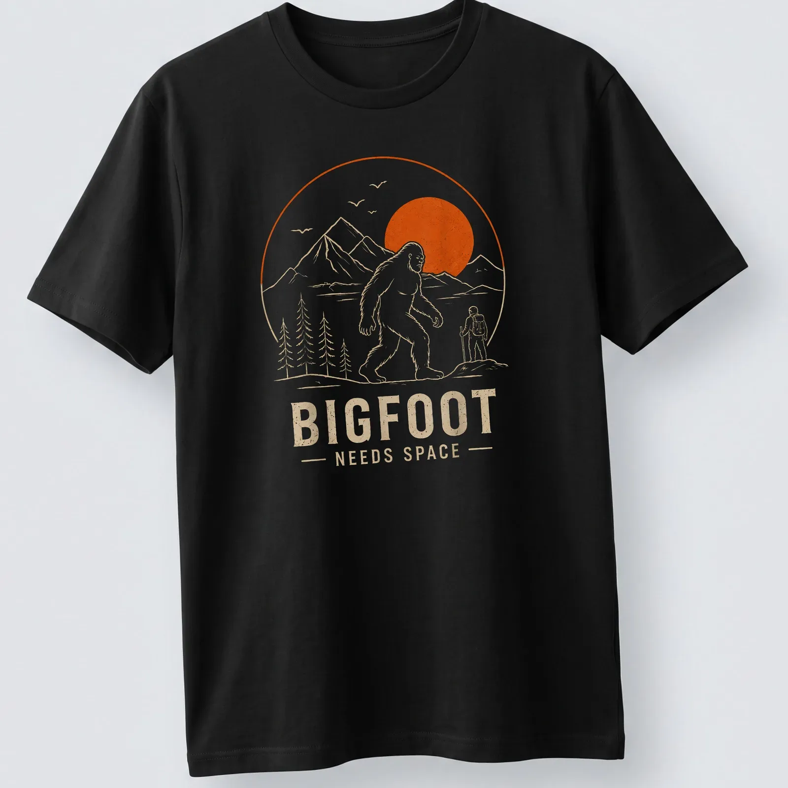 Line art design of Bigfoot with the text Bigfoot Needs Space in orange and beige — printed on a unisex t-shirt