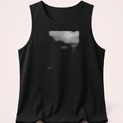 Cinematic blurred depiction of a plant shadow in black, white, and gray — printed on a tank top