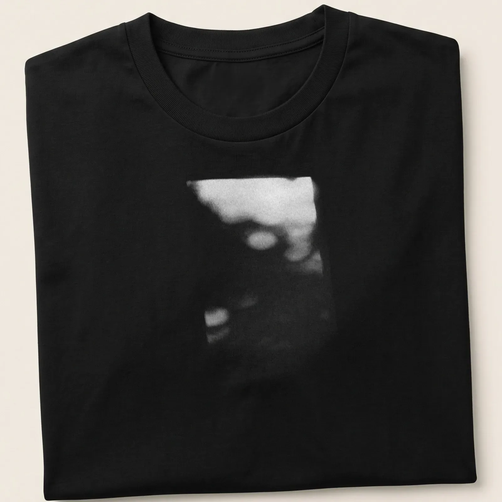 Cinematic blurred depiction of a plant shadow in black, white, and gray — printed on a unisex t-shirt