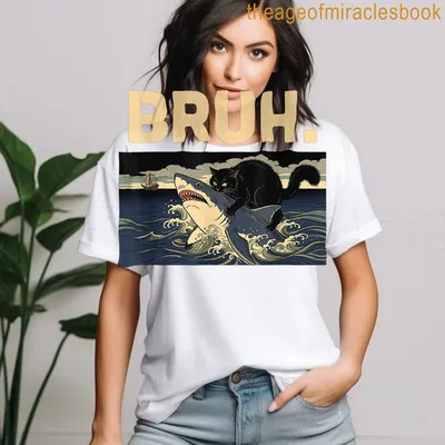 Illustration of a black cat riding a shark with the word BRUH above in bold text — printed on a women's t-shirt