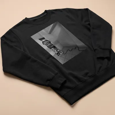 Black and white woven figure design representing winter travel. — printed on a unisex sweatshirt