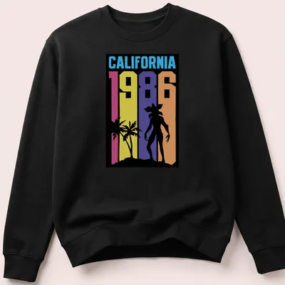 Retro California sunset silhouette t-shirt with vibrant colors and palm trees. — printed on a unisex sweatshirt