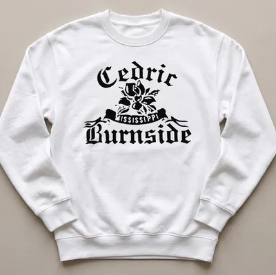 Bold vintage Cedric Burnside t-shirt featuring a magnolia flower and artistic text. — printed on a unisex sweatshirt