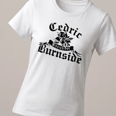 Bold vintage Cedric Burnside t-shirt featuring a magnolia flower and artistic text. — printed on a women's shirt
