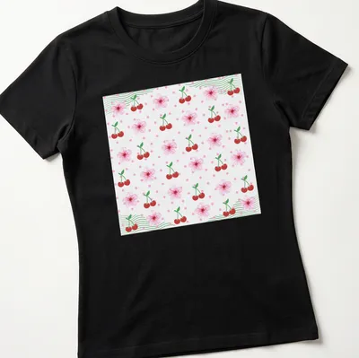 Floral pattern depicting cherries and cherry blossoms in pink, red, green, and white — printed on a women's shirt