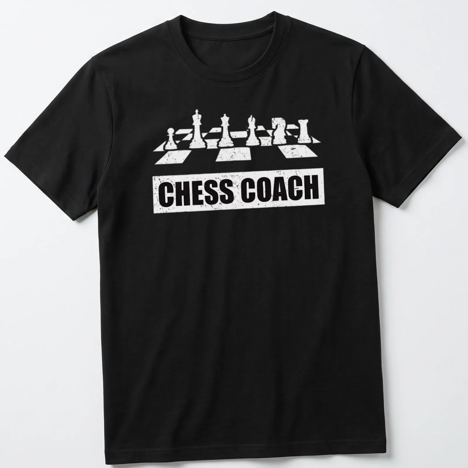 Bold Chess Coach t-shirt featuring chess pieces and simple typography — printed on a unisex t-shirt
