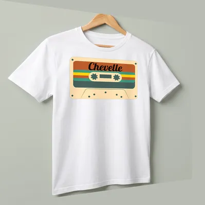 Retro design with the word Chevelle over a cassette tape in brown and cream tones. — printed on a unisex t-shirt (angled view)