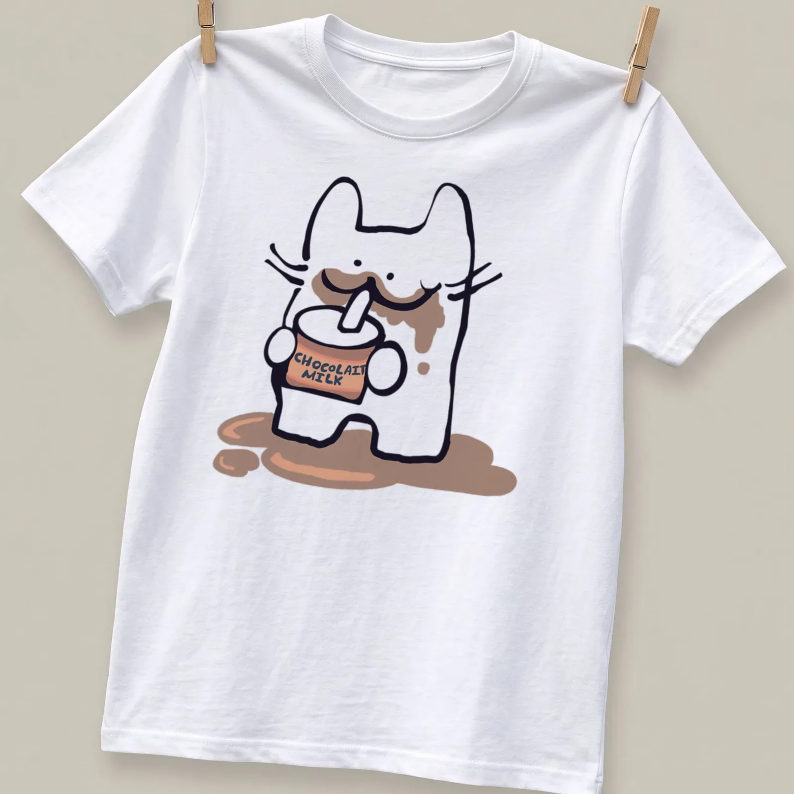 Kawaii character drinking chocolate milk with playful text CHOCOLAIT MILK — printed on a unisex t-shirt