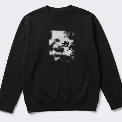 Cinematic blurred photo of a plant shadow in black, white, and green — printed on a unisex sweatshirt