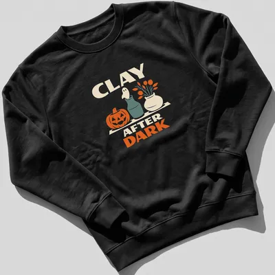 Retro design of a pumpkin and ghost with the text Clay After Dark for Halloween — printed on a unisex sweatshirt