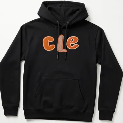 Embroidered patchwork t-shirt featuring "CLE" in orange and brown. — printed on a unisex hoodie
