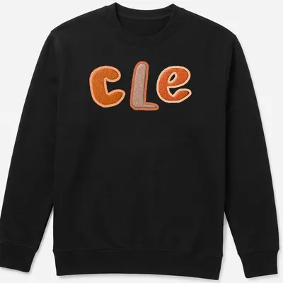 Embroidered patchwork t-shirt featuring "CLE" in orange and brown. — printed on a unisex sweatshirt