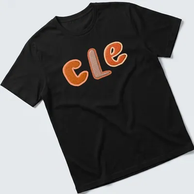 Embroidered patchwork t-shirt featuring "CLE" in orange and brown.