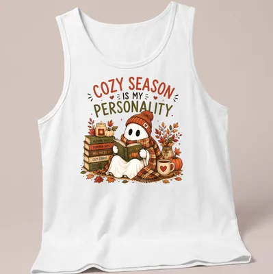 Whimsical illustration of a cute ghost reading with cozy season text — printed on a tank top