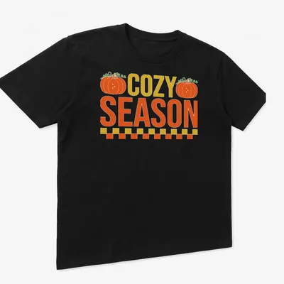 Vintage pumpkin design with the text COZY SEASON in warm autumn colors — printed on a unisex t-shirt (angled view)