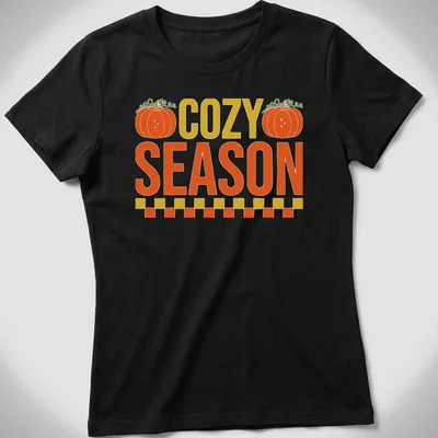 Vintage pumpkin design with the text COZY SEASON in warm autumn colors — printed on a women's shirt