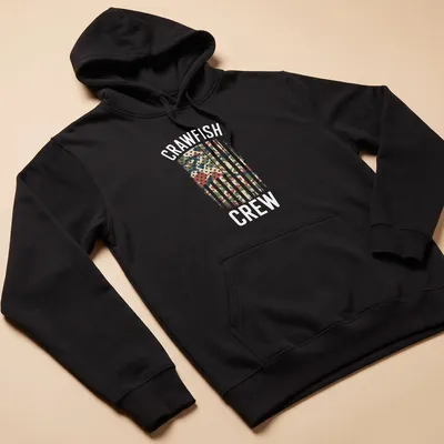 Distressed Crawfish Crew T-shirt featuring an American flag with camouflage pattern — printed on a unisex hoodie