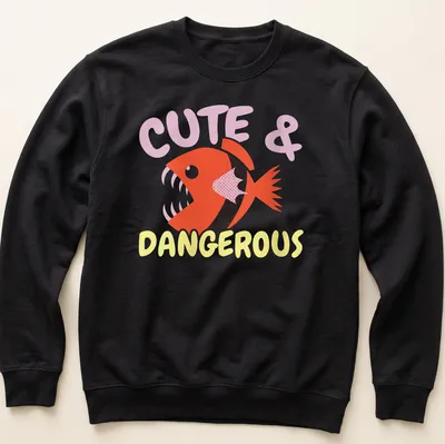 Playful cartoon piranha with vibrant colors and text Cute & Dangerous above it. — printed on a unisex sweatshirt