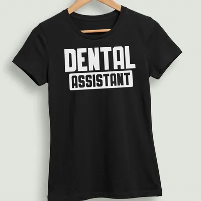 Bold typography tee with the words Dental Assistant in white lettering — printed on a women's shirt