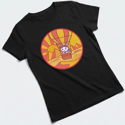Kawaii style design of a cat in a hot air balloon surrounded by a colorful landscape — printed on a women's shirt