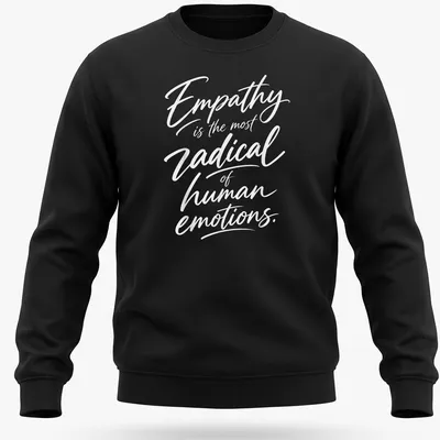 White typography on a shirt stating 'Empathy is the most radical of human emotions.' — printed on a unisex sweatshirt