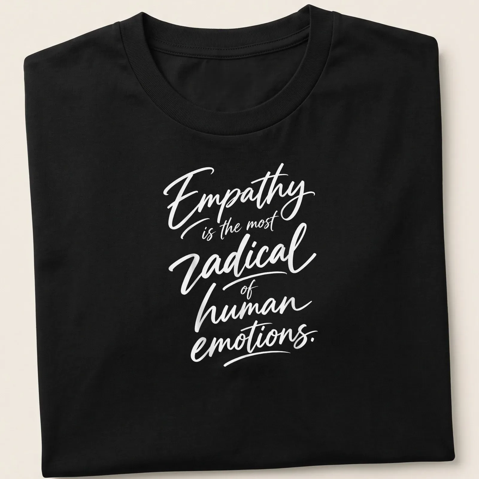 White typography on a shirt stating 'Empathy is the most radical of human emotions.' — printed on a unisex t-shirt