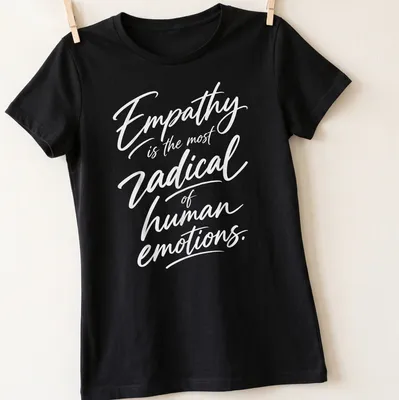 White typography on a shirt stating 'Empathy is the most radical of human emotions.' — printed on a women's shirt