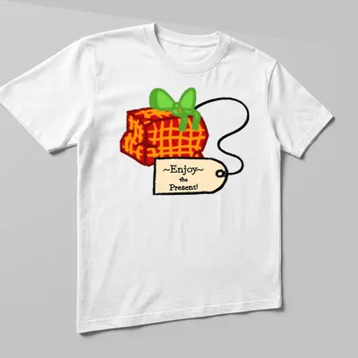 Playful cartoon gift box with colorful accents and the phrase ~Enjoy~ the Present! — printed on a unisex t-shirt (angled view)