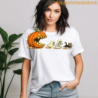 Cartoon Halloween T-shirt with a black cat chasing a pumpkin, ghost, and skeleton — printed on a women's t-shirt