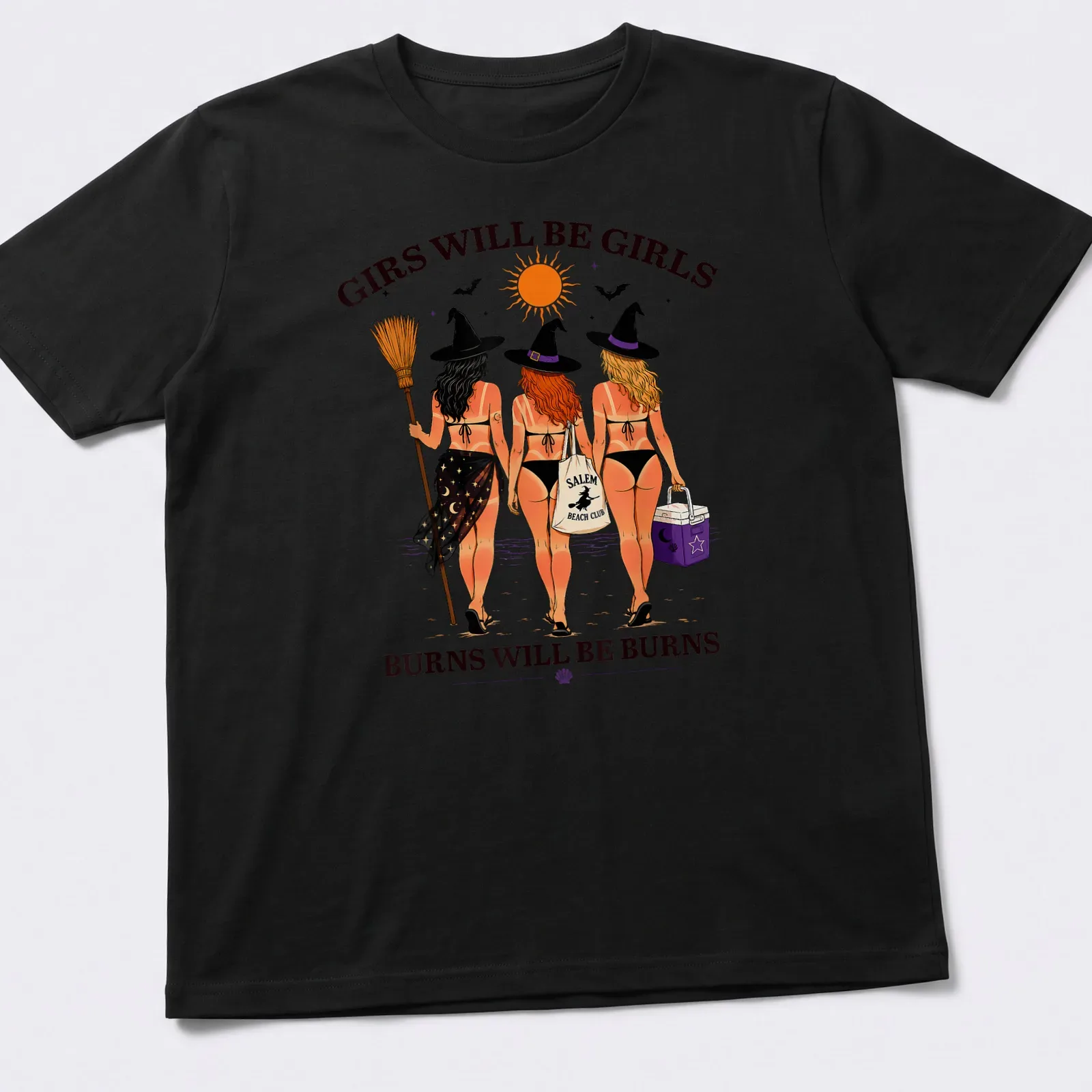 Colorful cartoon of three witches at the beach with playful text — printed on a unisex t-shirt