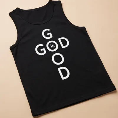 Bold typography T-shirt displaying 'God Is Good' Christian message in black and white — printed on a tank top