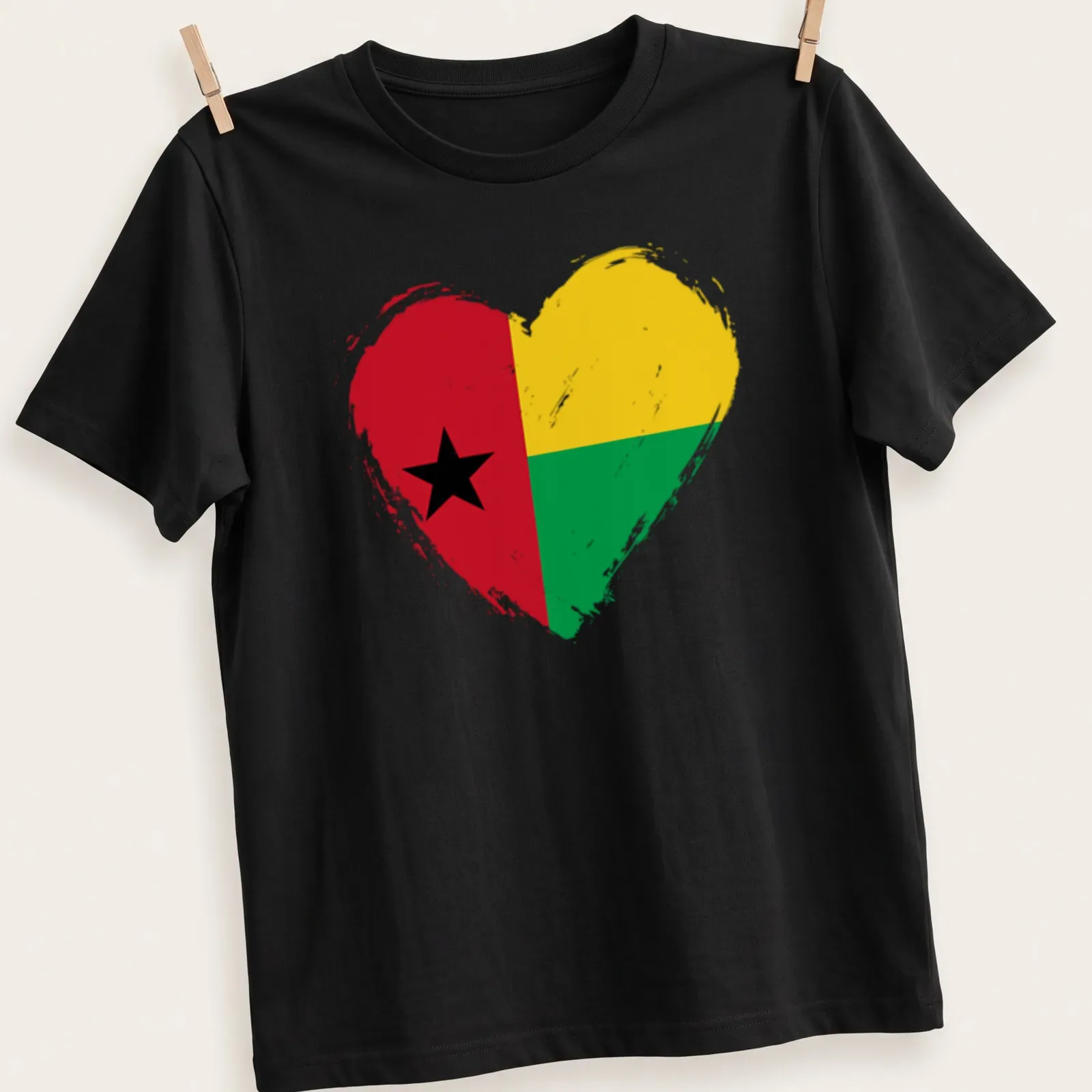 Distressed print of the Guinea Bissau flag in a heart shape with red, yellow, green, and black colors — printed on a unisex t-shirt