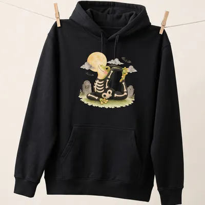 Cartoon tree frog in king pigeon yoga pose on black background with Halloween themes — printed on a unisex hoodie