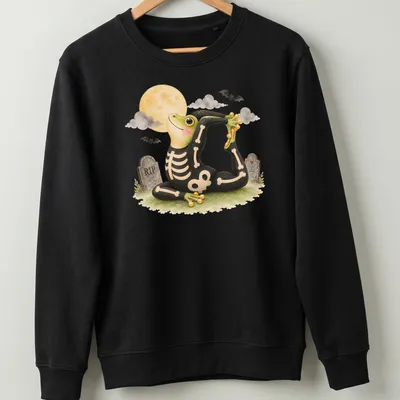 Cartoon tree frog in king pigeon yoga pose on black background with Halloween themes — printed on a unisex sweatshirt