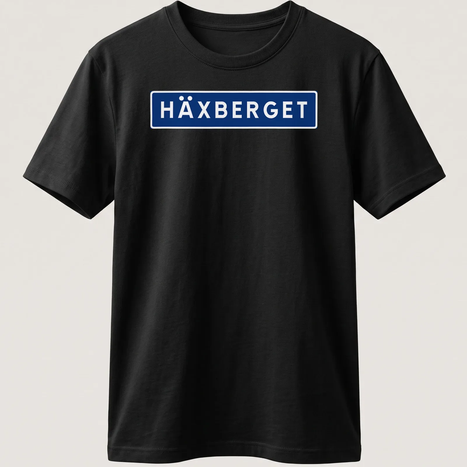 Simple modern HÄXBERGET shirt with bold blue and white lettering — printed on a unisex t-shirt