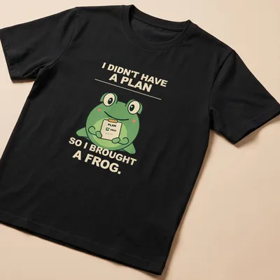 Cartoon frog with humorous text about spontaneity in green and beige — printed on a unisex t-shirt