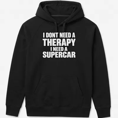 Bold typography t-shirt with the text I DONT NEED A THERAPY I NEED A SUPERCAR on a black background — printed on a unisex hoodie