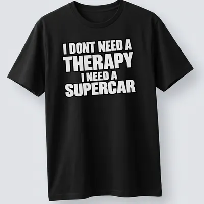 Bold typography t-shirt with the text I DONT NEED A THERAPY I NEED A SUPERCAR on a black background