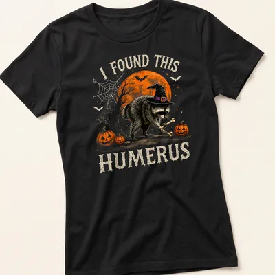 Whimsical raccoon illustration with humorous text for Halloween — printed on a women's shirt