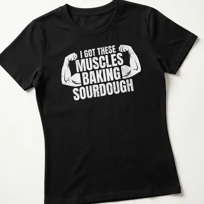 Distressed T-shirt with flexing arms and humorous baking text — printed on a women's shirt
