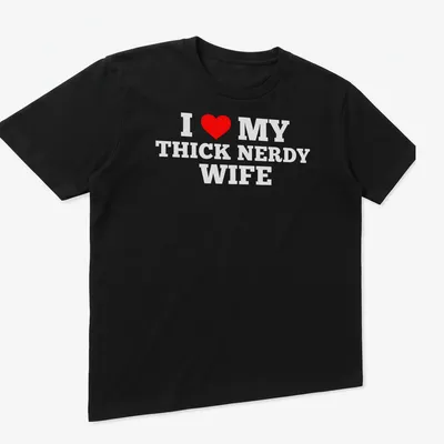 Bold text design declaring love for a thick nerdy wife with a heart symbol — printed on a unisex t-shirt (angled view)