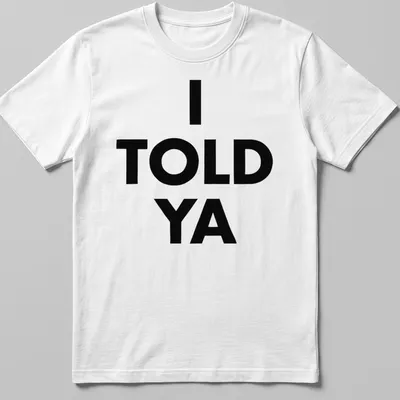 Bold typography t-shirt with the text 'I TOLD YA' in black and white