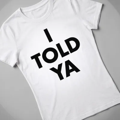 Bold typography t-shirt with the text 'I TOLD YA' in black and white — printed on a women's shirt